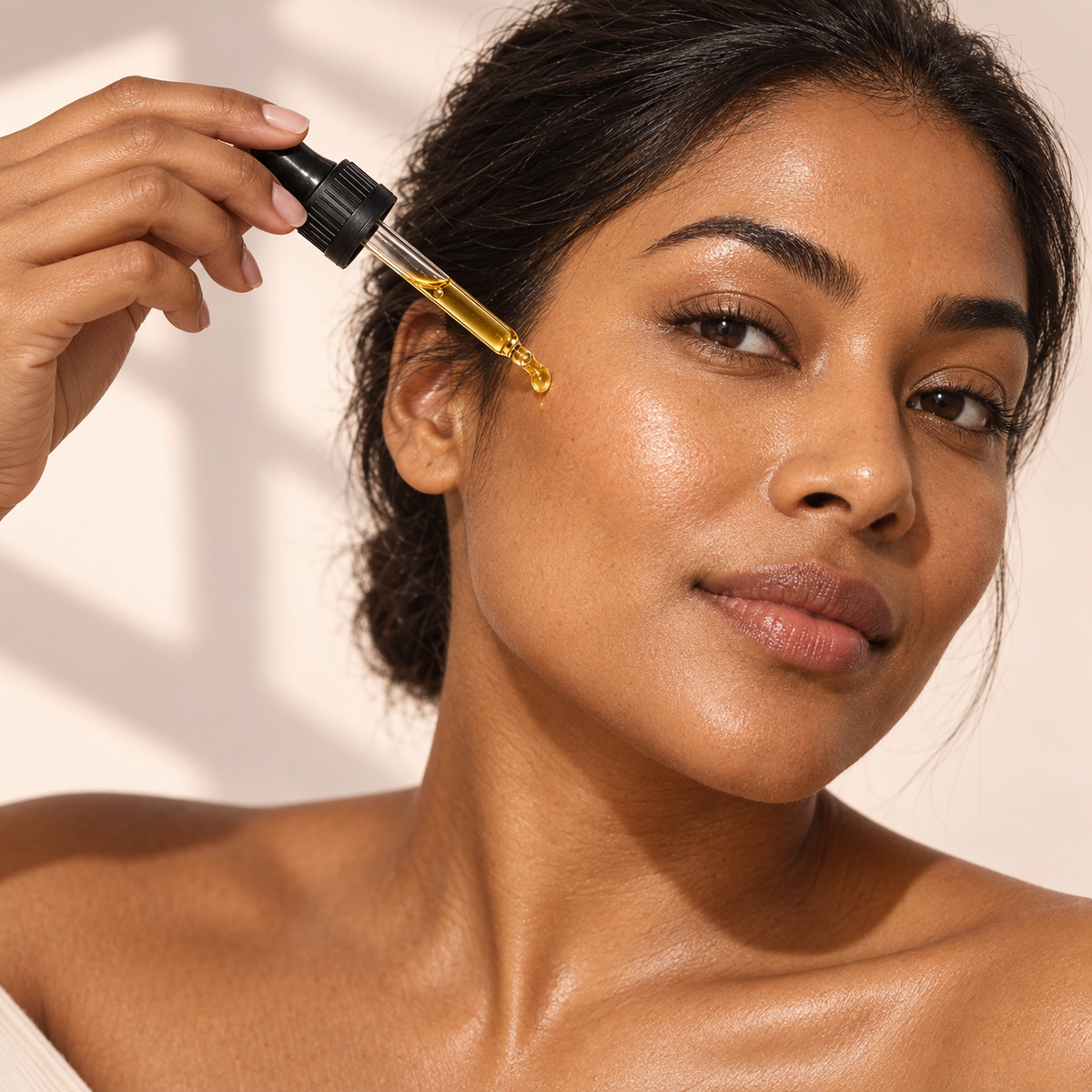 Woman applying Buff Chemistry Daily Facial Oil to healthy-looking skin.